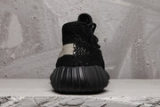 Rear view showing the black heel counter and vertically ribbed outsole.