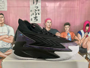 Side view of black and purple basketball sneakers resting on a box.