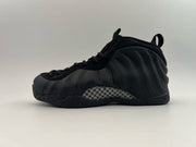 All-black high-top sneaker with a dark checkerboard side insert.