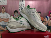 Pair of off-white and green PUMA sneakers, with a visible product tag identifying Reseule Lite Colored Block style 403302 03.