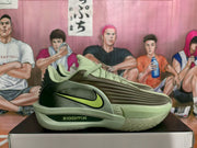 Side view of olive green Nike basketball shoes with a lime Swoosh and ZoomX lettering