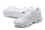 Pair of white Nike Air Max Plus sneakers with orange accents, shown from above and the side.
