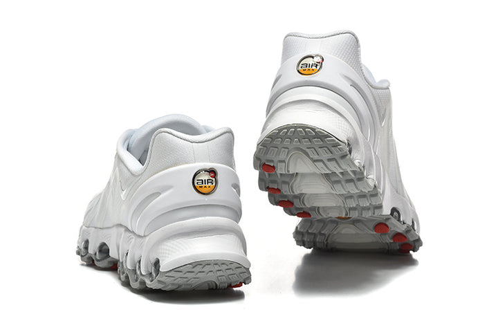 Rear and outsole views of white Nike Air Max DN sneakers with gray tread and red accents.