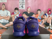 Rear view of the pink and purple Nike basketball shoes showing padded collars and gold embroidered heel details.