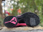 Close view of the patterned black outsole and pink accents