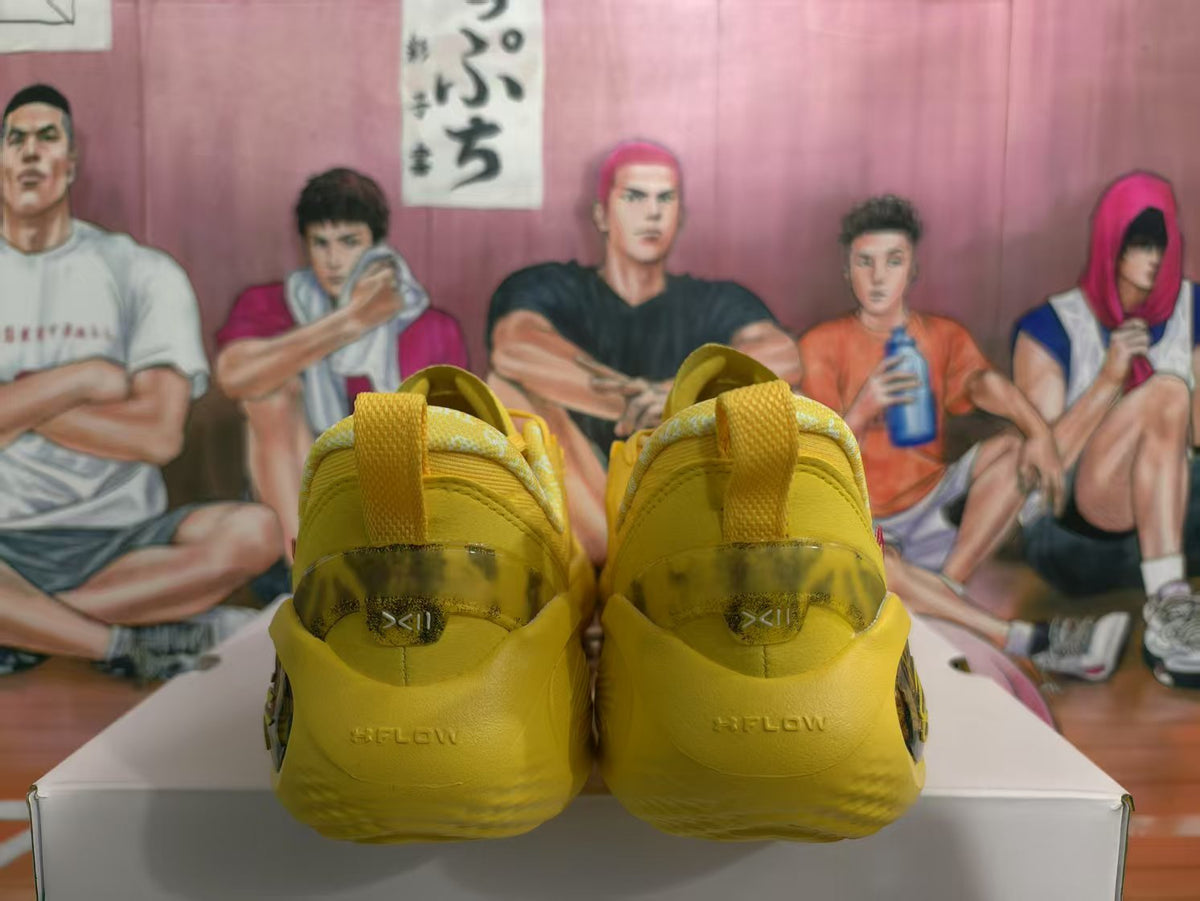 Rear view of yellow basketball sneakers showing the pull tabs, heel lettering, and translucent heel panels.