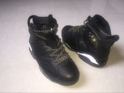 Front and rear angled view of the black sneakers with perforated toe boxes and padded high-top collars.