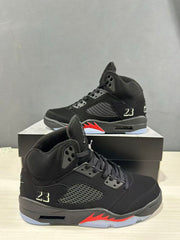 Close angled view of the black high-top sneaker with perforated side panel and number 23 detail
