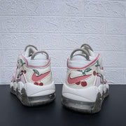 Rear view showing pink heel logos and cherry graphics on the sneakers