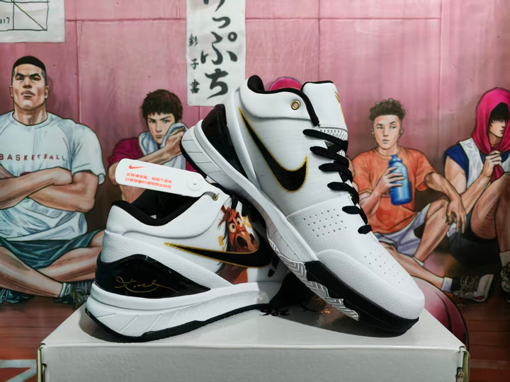 White and black Nike basketball-style sneakers with gold accents and graphic side artwork displayed on a box.