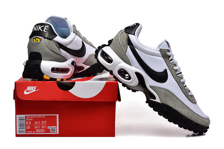 Nike Air Max TW sneakers in white, grey, and black shown with a red Nike shoe box; the box label shows sample sizes.