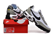 Nike Air Max TW sneakers in white, grey, and black shown with a red Nike shoe box; the box label shows sample sizes.