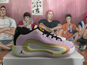 Side view of a lavender-pink Jordan sneaker with black laces, green sole accents, and a visible Jumpman logo on a box.