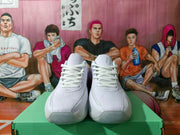 Front view of white lace-up sneakers with perforated toe panels