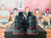Rear view showing glossy black heel panels, red outsole accents, and signature-style heel details.