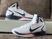 White high-top basketball shoes with black and red details shown from the side