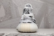 Rear view of the sneaker showing the padded heel area, patterned upper, and rounded sole.