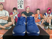 Front view of blue Nike basketball sneakers with textured uppers, blue laces and white side Swooshes.