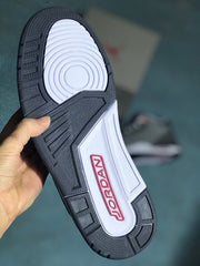 Underside view of the sneaker with a dark outsole and white midfoot section