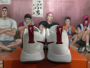 Rear view showing the padded heels, red pull tabs, and dark red outsoles of the Nike sneakers.