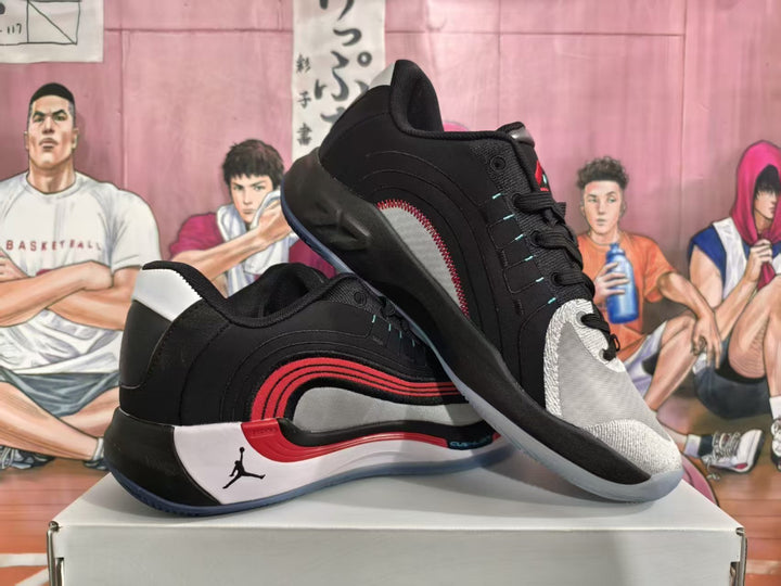 Pair of black, white, and red Jordan basketball sneakers displayed on a shoebox.