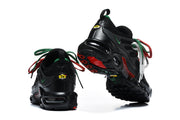 Rear and outsole views of black Nike Air Max Plus sneakers with red and green details.