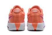 Rear view of the coral sneakers showing perforated heel panels, white midsoles, and purple side accents.
