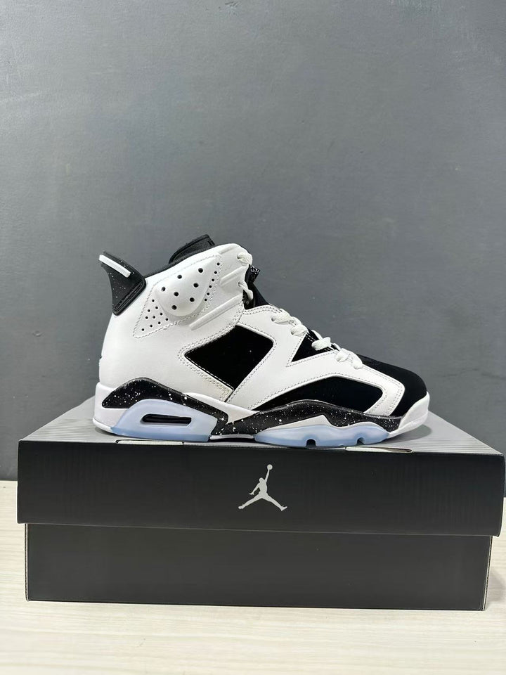 Side view of a white and black Jordan Air Jordan 6 high-top sneaker displayed on a black shoebox.