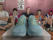 Front view of blue basketball sneakers with contrasting laces