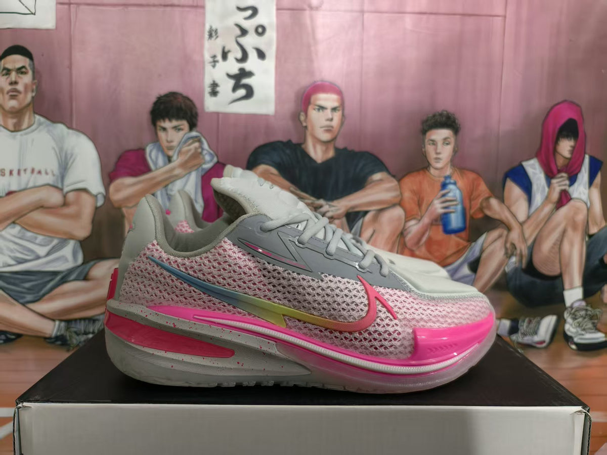 Gray and pink Nike GT basketball sneaker shown in side profile on a shoebox.