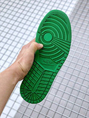 Close-up of the green outsole with circular traction and patterned tread.