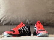 Front view of the pair showing red tongues and translucent-looking soles