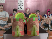Rear view of pink Nike basketball shoes showing lime-green heel details and patterned uppers