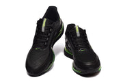 Front view of black Nike Pegasus Premium shoes with green details