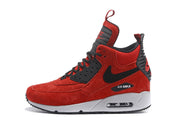Side profile of a red and black Nike Air Max 90 high-top sneaker with visible heel Air window.
