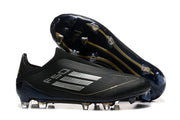 Black adidas F50 soccer cleat beside its outsole, showing the stud configuration.