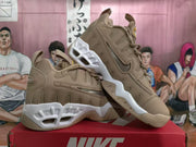Brown Nike sneakers shown from the side, with one shoe tilted to display the sole.