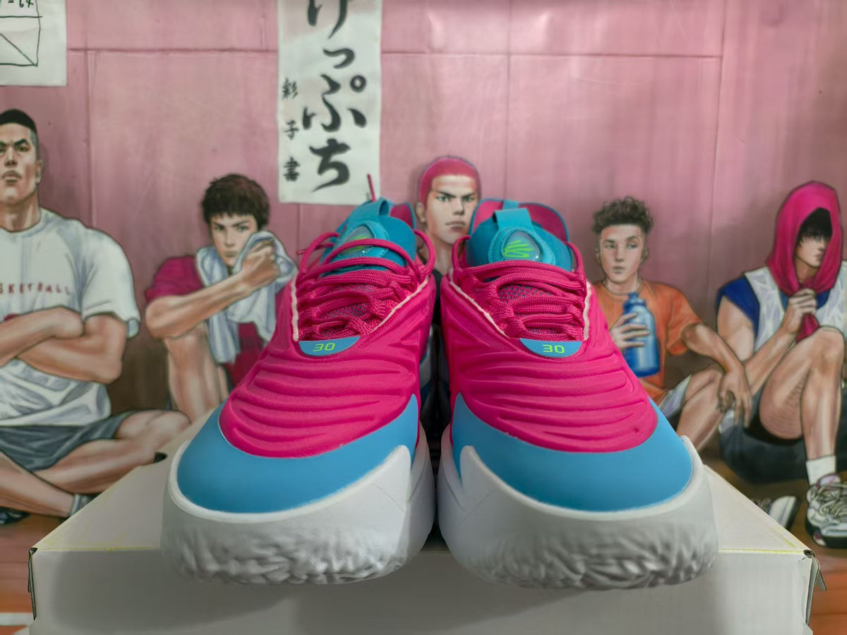 Front view of pink and blue sneakers with white midsoles displayed on a box.