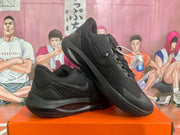 Angled view of a pair of black Nike sneakers showing the laces, toe panels, side branding and outsole tread.