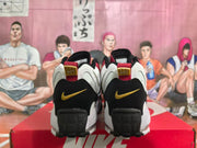 Rear view showing black heel panels, gold-toned Nike logos, and red pull tabs.