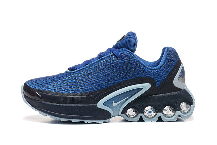 Side view of a blue and black Nike kids’ sneaker with a mesh-patterned upper and heel pods.