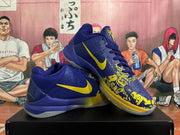 Angled view of blue and yellow Nike basketball sneakers showing side Swooshes, graphic forefoot panels, and translucent outsoles.