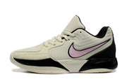 Side profile showing the pink side branding, black heel and layered cream panels