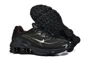 Black Nike Shox Ride 2 sneakers shown from the side and underside, highlighting the patterned outsole.