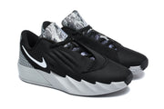 Pair of black Nike Ja basketball shoes with white Swooshes and grey patterned heel and tongue panels.