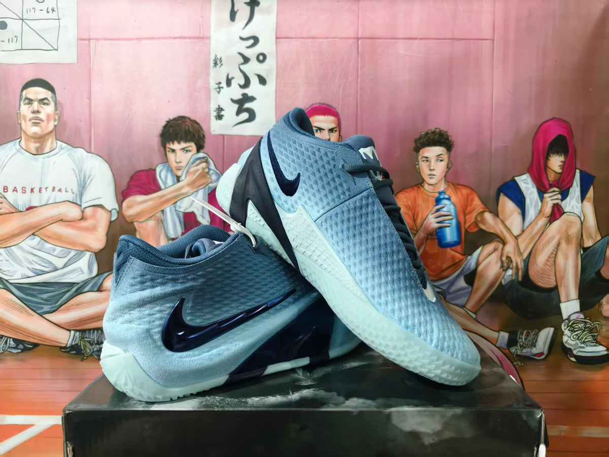 Gray-blue Nike basketball shoes with dark navy accents, shown at an angle