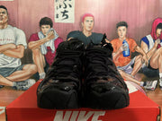 Front view of black lace-up high-top sneakers with textured toe sections.
