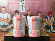 Rear view of white and pink Jordan high-top sneakers showing the heel tabs and raised 23 details.