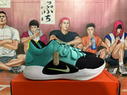Side view of a teal and black Nike basketball shoe with volt swoosh detail