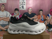 Side view of a black and white On sneaker showing the logo and CloudTec Phase text